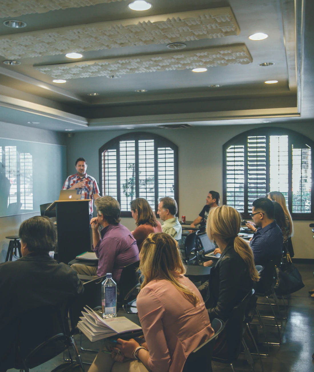 Professionals taking part in a training session in a bright meeting room