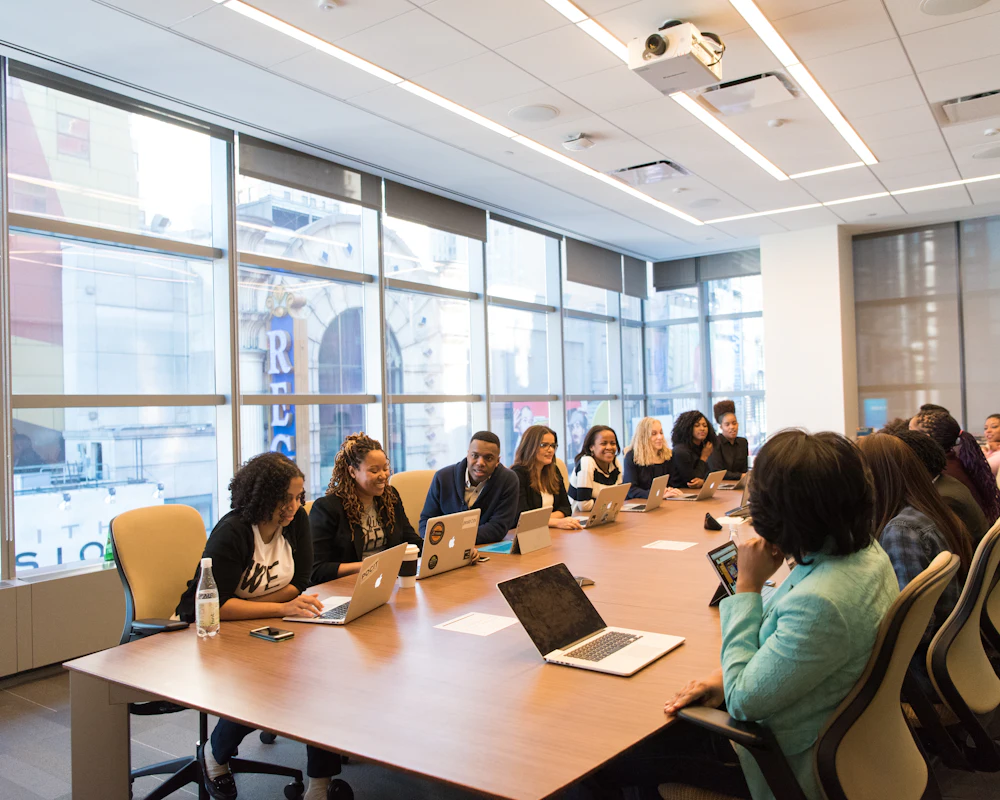 A panel of professionals seated around a long boardroom table