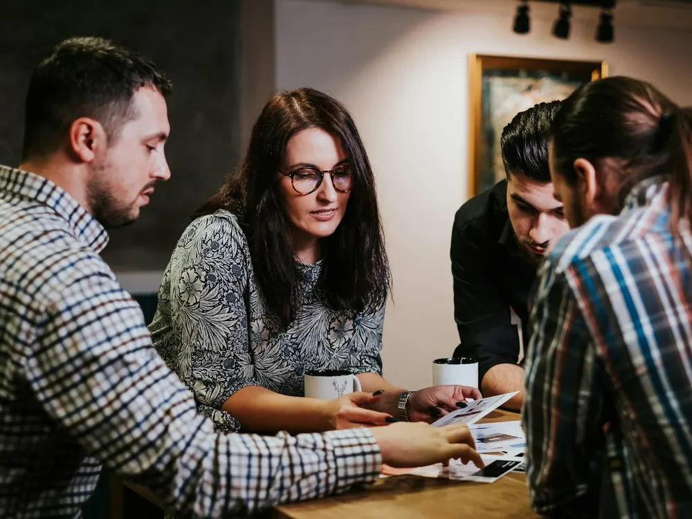 A team discussing documents around a table