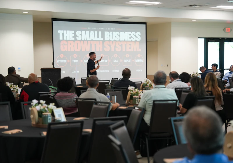 A speaker presenting to a full room at a professional summit